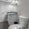 Well-lit bathroom with a large mirror