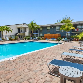 Resort-style swimming pool with lounge seating
